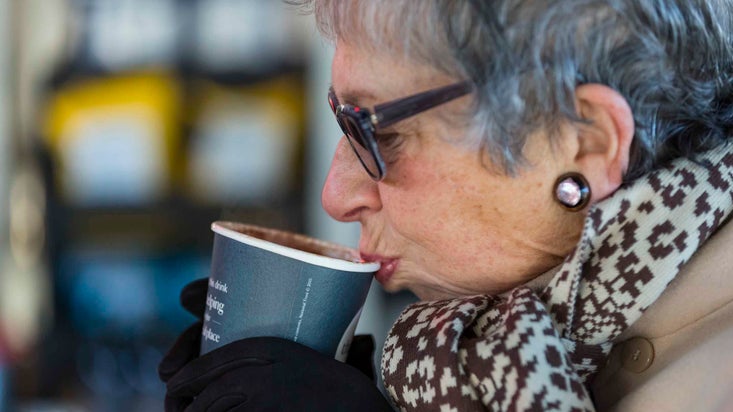 A visitor drinking from takeaway cup